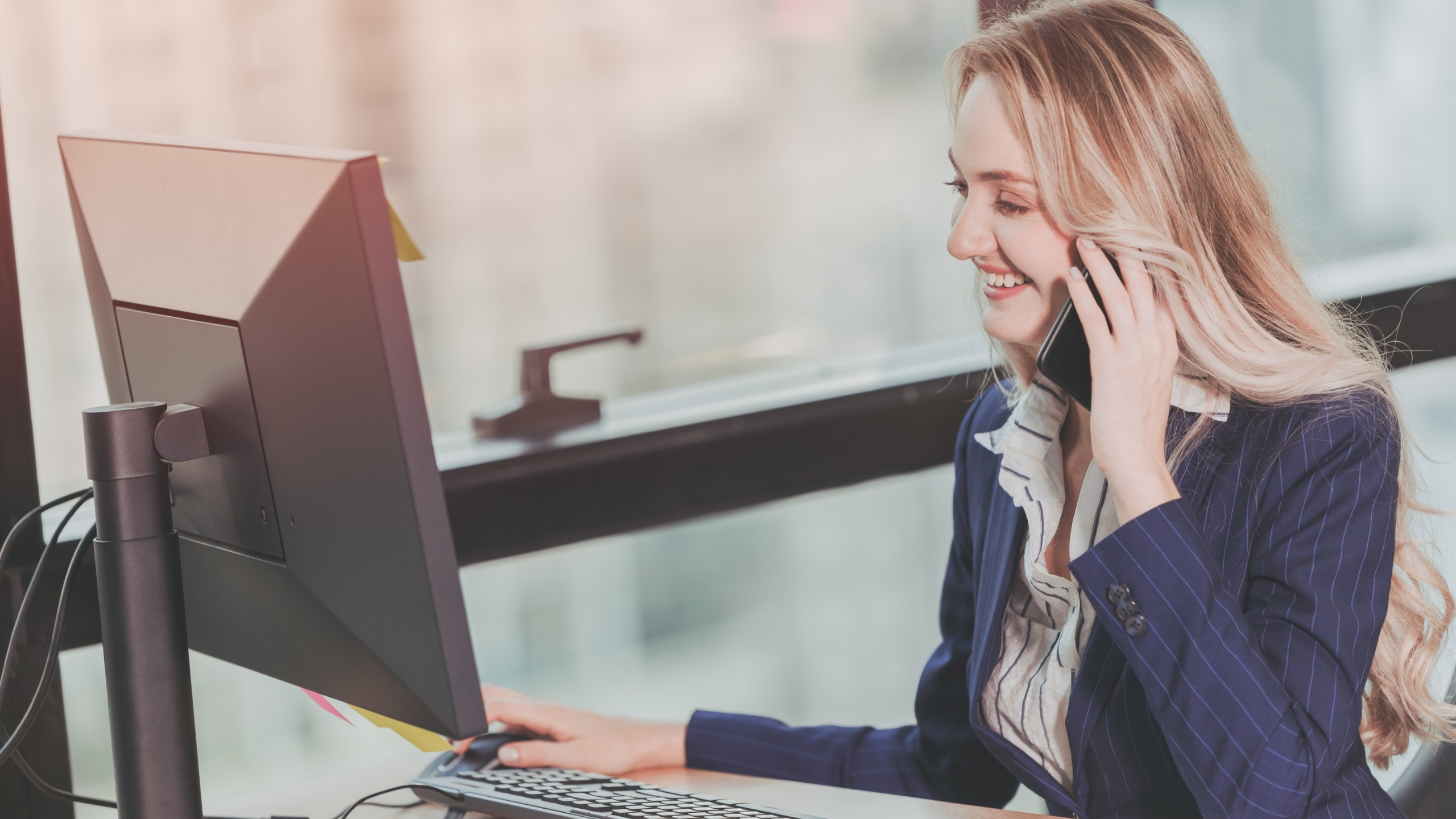 Business professional speaking with a customer by phone