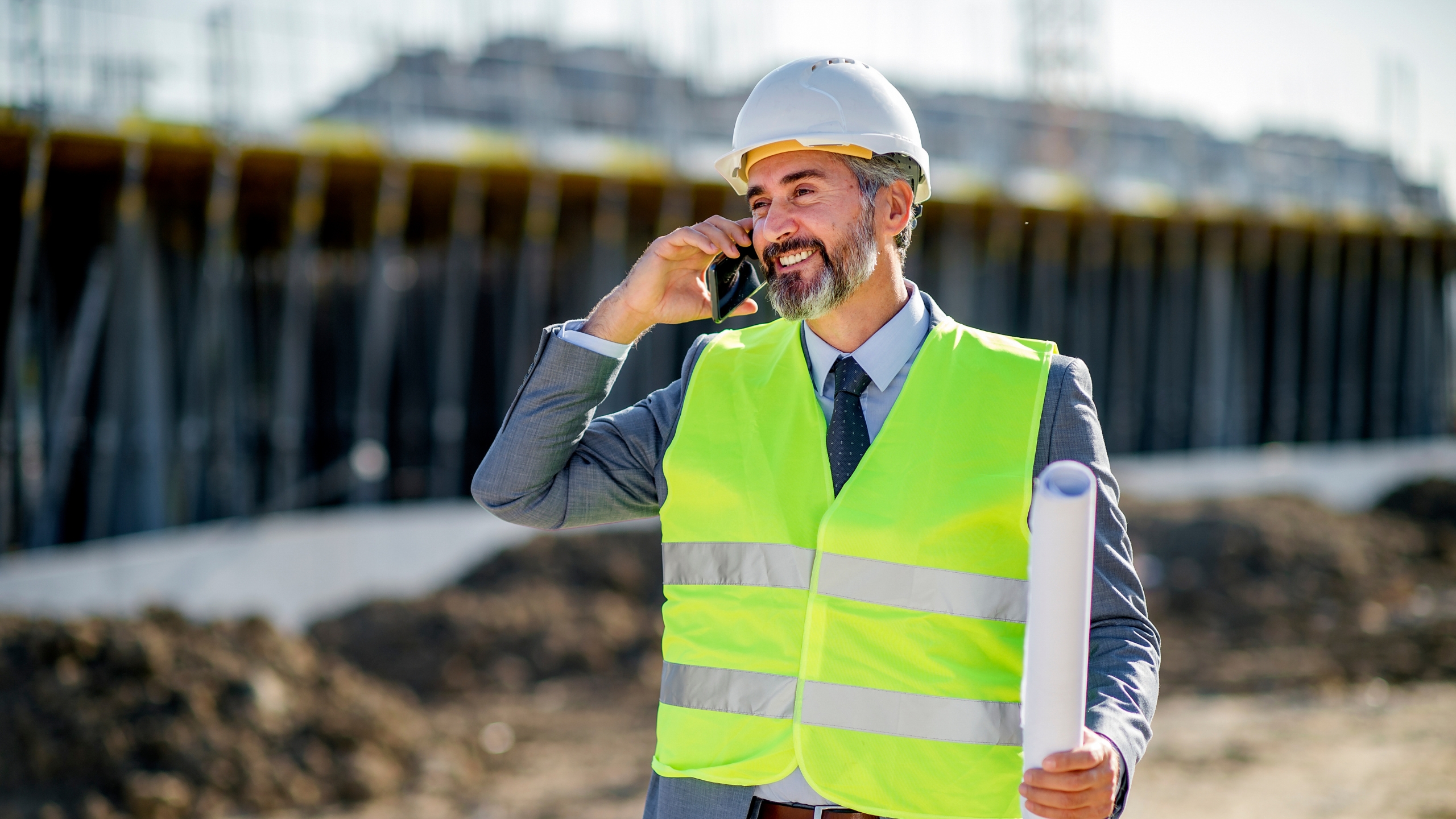 Field professional using a phone at a job site